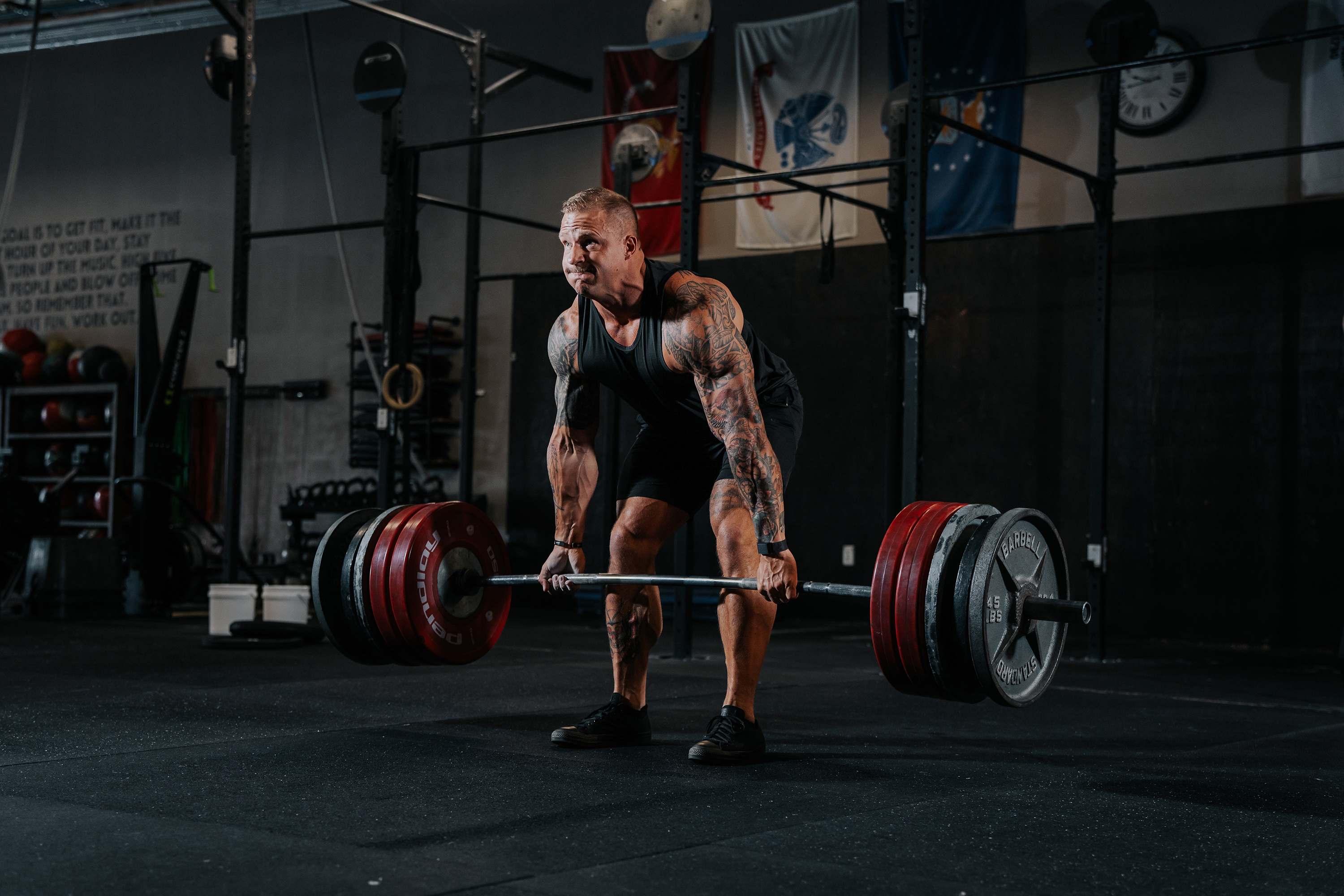 LINEAR Clothing athlete Chris Jacob wearing Baseline Series Tank and shorts running doing dead lifts in the gym