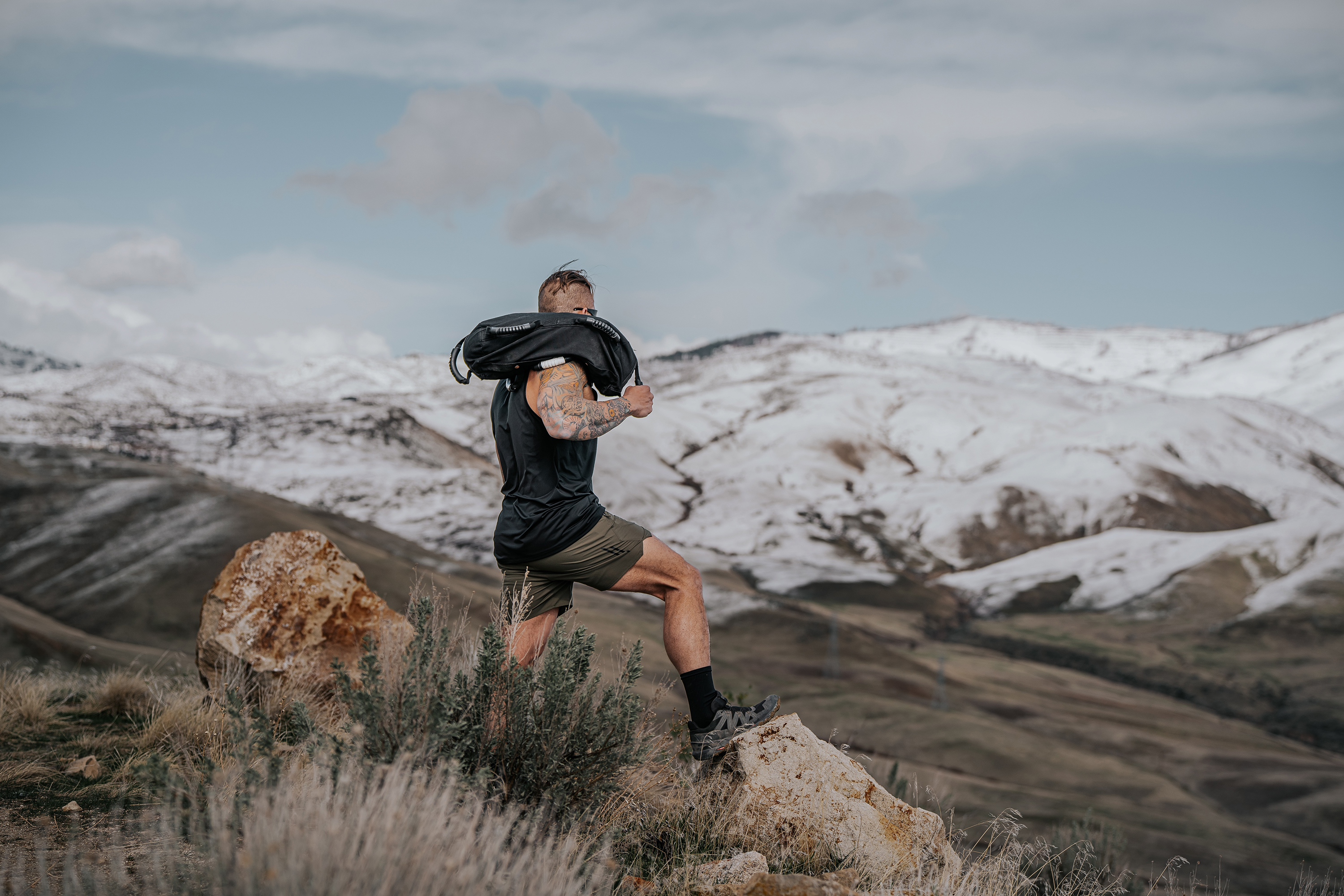 LINEAR Clothing model wearing Baseline Series Tank and shorts standing in the mountains
